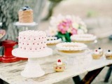 simple glass and white stands for an assortment of wedding cakes on a shabby chic table