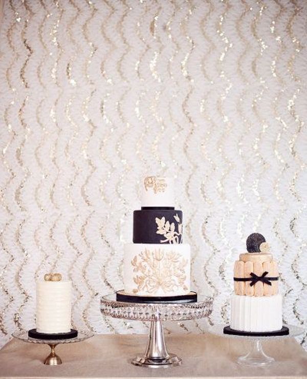 sheer stands don't distract attention from white, black and blush wedding cakes with blooms and bows