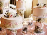 creative cake stands – glasses filled with dried flower petals finish off the look of the cakes with fresh blooms and greenery