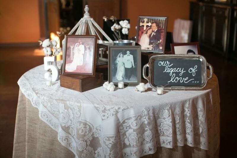 an honoring table with some family photos, a chalkboard sign and some candles is a lovely idea for a wedding
