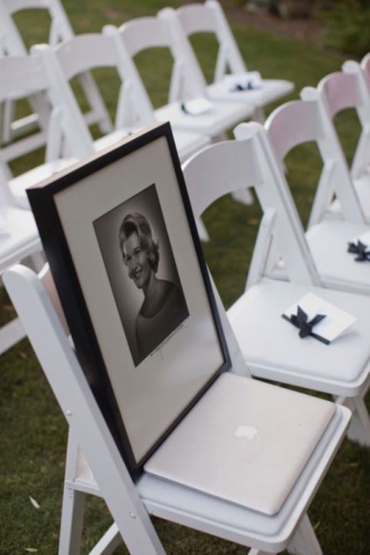 a chair left for a person who is gone, with a black and white photo of this person is a cool idea for a wedding