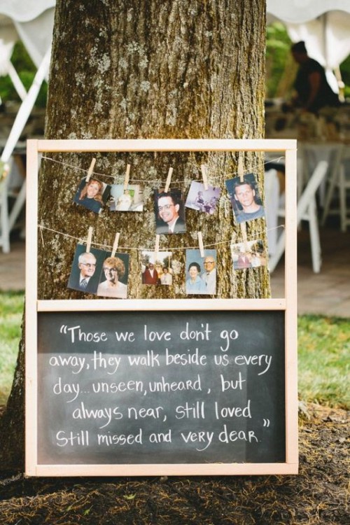a rustic decoration that includes banners with photos of those who are gone and a chalkboard with a quote about love to these people
