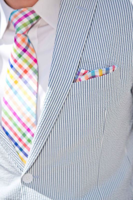A bright summer groom's look with a thin striped suit, a bright plaid tie and a handkerchief is a gorgeous idea for a colorful summer wedding