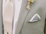 a delicate spring groom’s look with a light grey suit, a white shirt, a tan tie, a floral boutonniere and a printed handkerchief is a chic idea