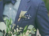 a navy wooled suit, a grey shirt, a navy bow tie and a dark floral handkerchief plus a greenery boutonniere for an ultimate fall groom’s look