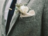 a chic groom’s look with a grey woolen suit, a white shirt, a black tie and a white handkerchief plus a white bloom in the square pocket