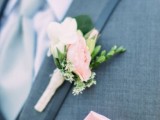 a classic groom’s look with a grey suit, a white shirt, a pastel blue tie, a pink floral boutonniere and a pink handkerchief never goes out of style