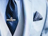 an ocean-style groom’s look with a light blue three-piece suit, a thin stripe shirt, a navy tie and a navy polka dot handkerchief is a chic and catchy idea to rock