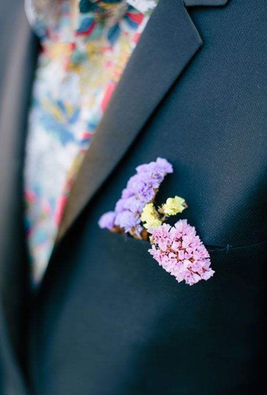 A chic black suit, a bold floral tie and delicate pastel blooms is a super bold and catchy combo for a wedding with a bright color scheme