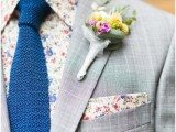 a colorful floral boutonniere and a bold floral shirt plus a matching handkerchief in the pocket square is amazing