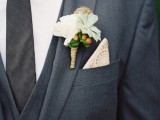 a laconic groom’s look with a graphite grey three-piece suit, a white shirt, a thin tie, a white floral boutonniere and a doily pocket square is chic
