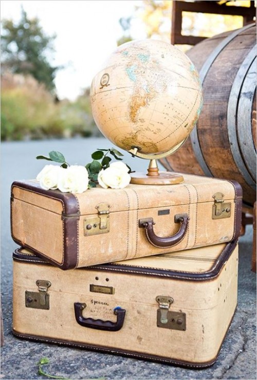 a stack of vintage suitcases with white blooms, a globe is a pretty decoration that will be perfect for a couple of travelers