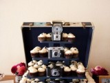 a vintage suitcase with a cupcake stand and vintage cameras for decor is a creative idea for a vintage wedding that cna be easily DIYed
