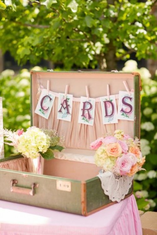 a vintage suitcase with a card banner and some blush blooms is a great idea for cards, this is a nice solution for a vintage wedding