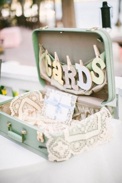 a pastel suitcase with a letter banner, lace and a letter is a nice storage unit for wedding cards, great for a spring wedding