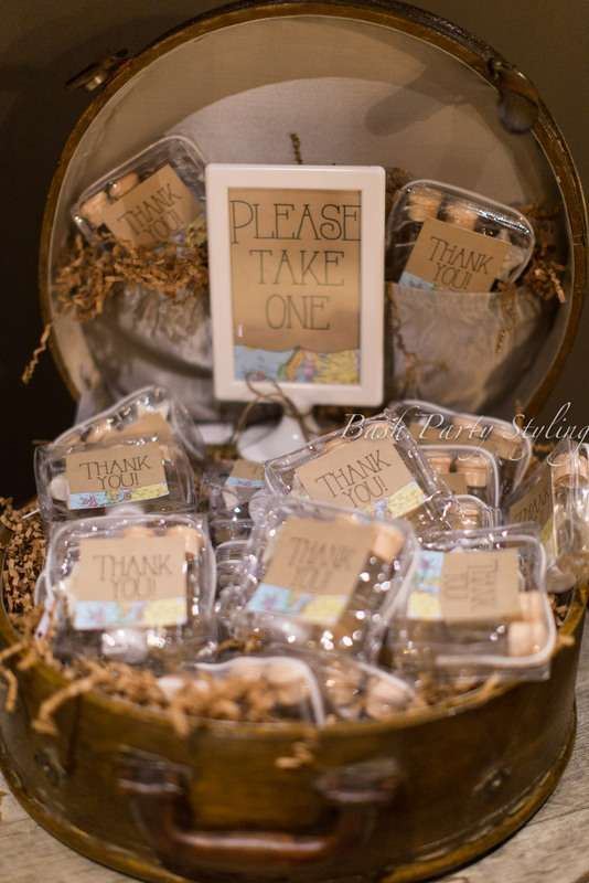 A vintage round suitcase filled with paper and with wedding favors with cards is a cool idea for a vintage or rustic wedding