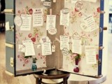 an oversized vintage suitcase with floral wallpaper and a seating chart inside is a very cool idea to rock at a vintage wedding and you can DIY it