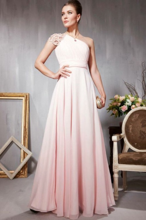 a blush A-line one shoulder wedding dress with an embellished cap sleeve and a pleated skirt