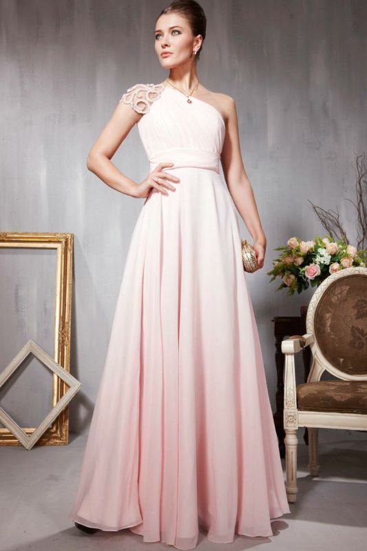 a blush A line one shoulder wedding dress with an embellished cap sleeve and a pleated skirt