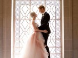 an ombre pink and white wedding ballgown with a strapless bodice and a layered skirt with a train