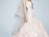 a strapless blush mermaid wedding dress with a draped bodice and skirt plus a long train
