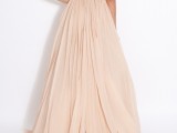 a blush A-line wedding dress with a fully embellished bodice with short sleeves, an open back and pleated skirt