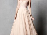 a blush strapless A-line wedding dress with a lace bodice and a plain skirt is a pastel take on classics