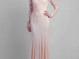 a blush mermaid wedding dress with a lace bodice and long illusion sleeves plus a plain skirt with pleating