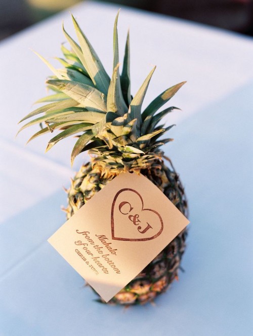a pineapple with a gift tag is a perfect tropical wedding favor