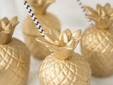gilded pineapple jars for drinks will perfectly match any tropical-themed wedding event