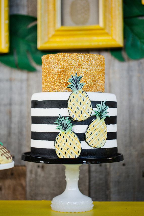 A fun wedding cake with a tropical and gold glitter tier and fun pineapples attached is a bold and cool idea for a modern tropical wedding