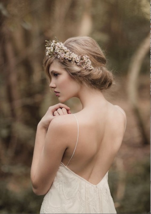 a pretty twisted updo with side bangs and some fresh and dried blooms for an accent is a lovely idea for a boho bride