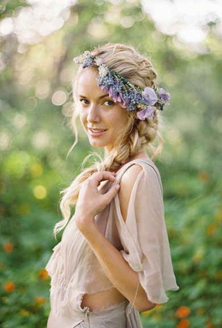 a boho chic hairstyle with a side braid, a lilac and purple floral crown is a cool idea for a boho bride in spring or summer