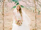 a vine wedding arch decorated with cherry blossom is a real spring-like dream