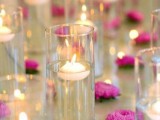 tall glasses with floating candles and some blooms on the table are great for a modern and fresh Valentine’s Day centerpiece