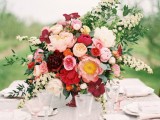 a refined Valentine’s Day wedding centerpiece of red, blush and white blooms and greenery is a beautiful and chic idea