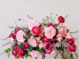 a gorgeous lush Valentine’s Day wedding centerpiece of fuchsia, light pink and blush blooms and greenery is adorable