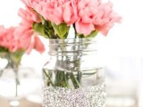 a silver glitter jar with pink blooms is a pretty glam arrangement to rock, it’s romantic and bold