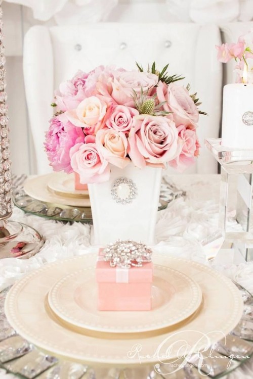 a white embellished bucket with pink and blush roses is a pretty glam and bright Valentine's Day wedding centerpiece