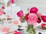 a simple and bright Valentine wedding centerpiece of pink and fuchsia blooms in a sheer vase is perfect for celebrating