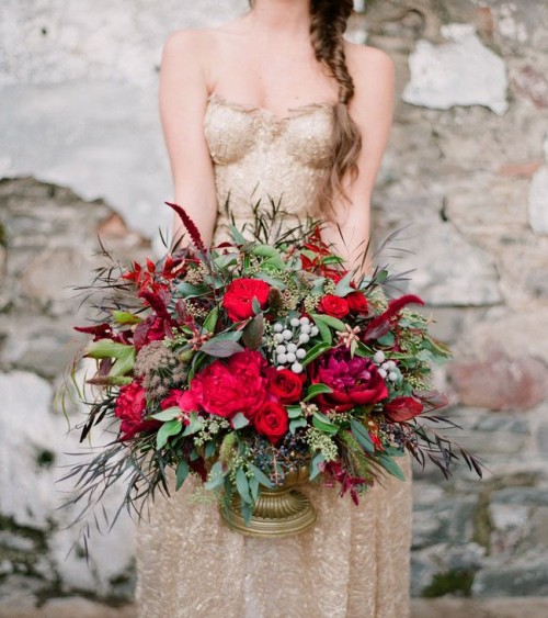 a bold and bright Valentine's Day wedding centerpiece of burgundy blooms and greenery is a very beautiful idea to rock