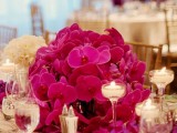 a bright and chic Valentine’s Day wedding centerpiece of fuchsia colored orchids is a lovely and bold idea to rock