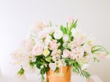 a tender blush and white floral weddng centerpiece like this one will fit a Valentine’s Day wedding or any other