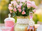 a gold glitter vases with a lace ribbon and bright pink blooms is a very chic, glam and bright Valentine’s Day wedding
