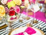a colorful Valentine’s Day wedding centerpiece of a mercury glass bowl and lots of colorful flowers is amazing