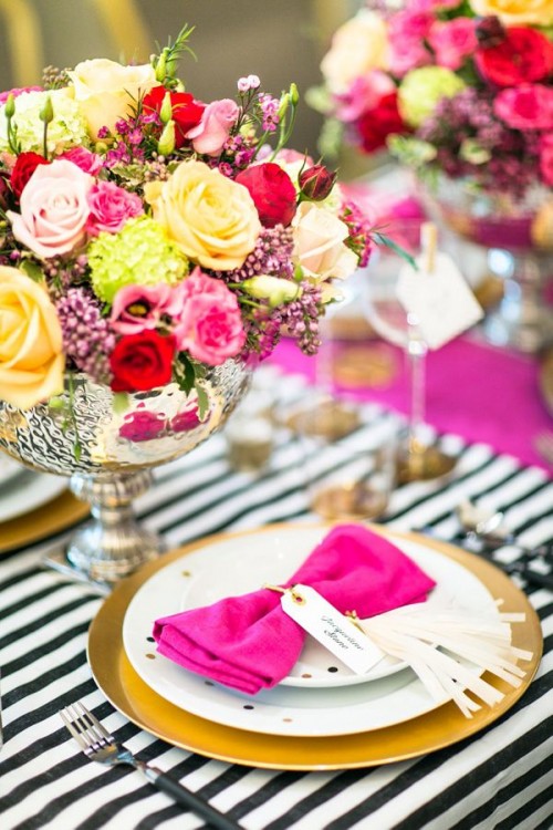 a colorful Valentine's Day wedding centerpiece of a mercury glass bowl and lots of colorful flowers is amazing