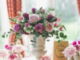 a vintage urn with lavender, lilac and purple blooms and eucalyptus is a lovely vintage idea for a Valentine’s Day