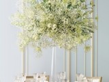 a lush white floral centerpiece of a clear vase is an elegant option not only for a winter wedding but also for another one
