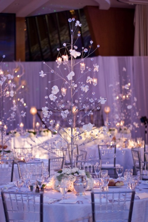 a glass Christmas tree with crystals, flowers, candles in candleholders is a very refined and elegant option