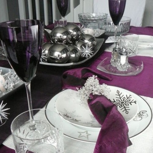 a bowl with dark Christmas ornaments and snowflakes is a winter wedding centerpiece